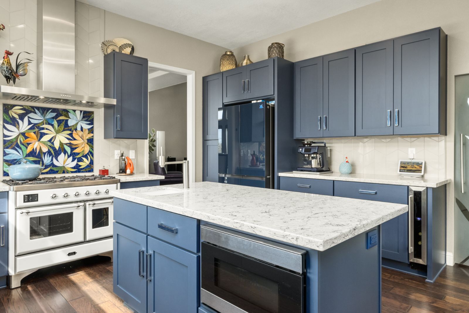 Custom painted shaker cabinets and quartz island with built-in microwave drawer