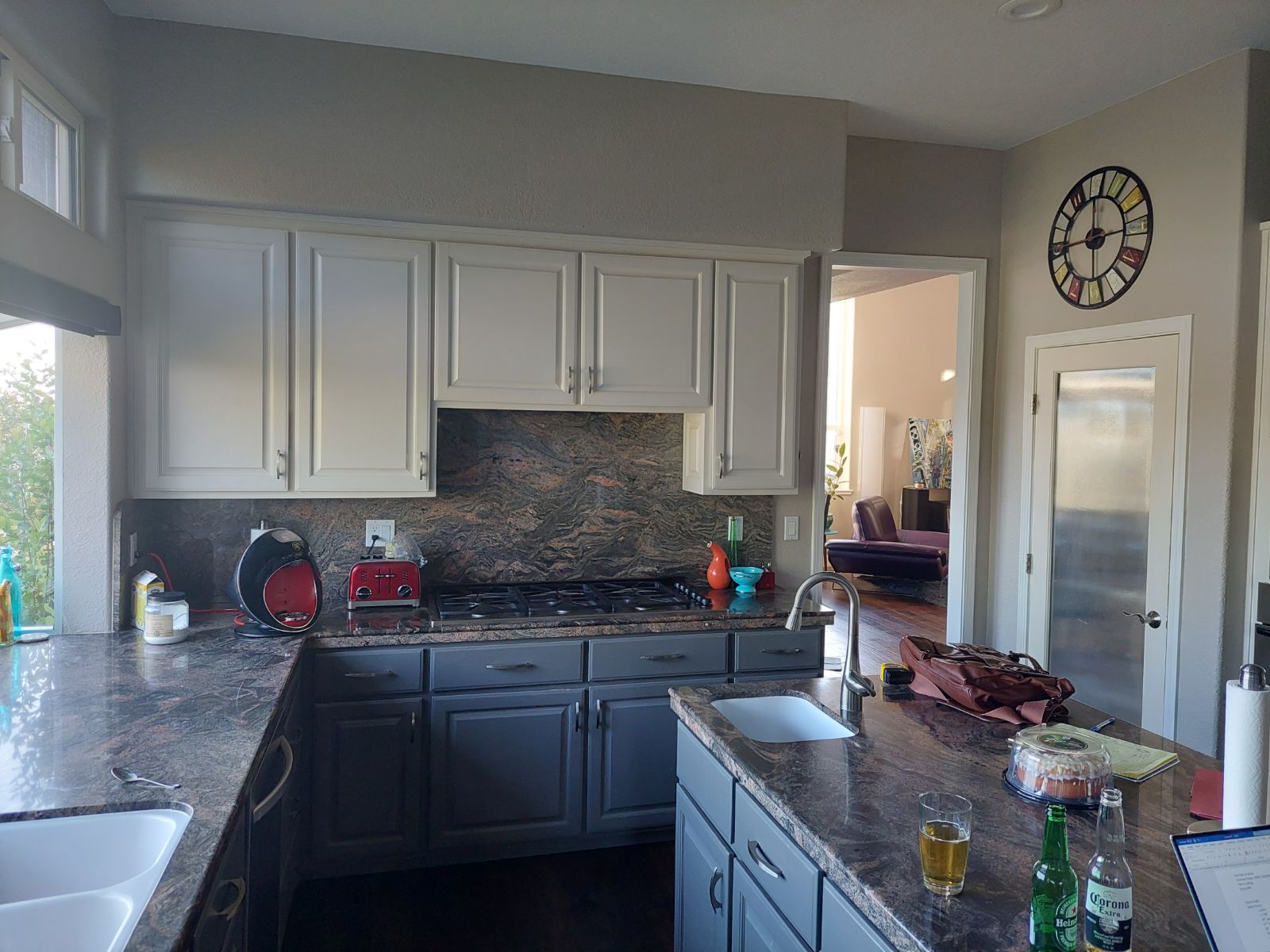 Original kitchen with painted raised-panel cabinets, dark granite counters and a full granite backsplash